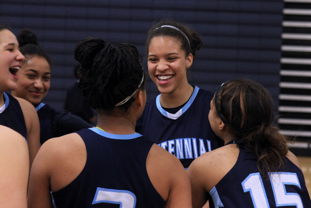 Centennial guard Jayden Eggleston, center right, celebrates a victory over Liberty in the ch ...