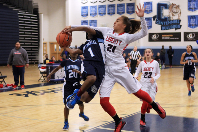 Centennial guard Pam Wilmore is fouled by Liberty guard Kaily Kaimikaua during the champions ...