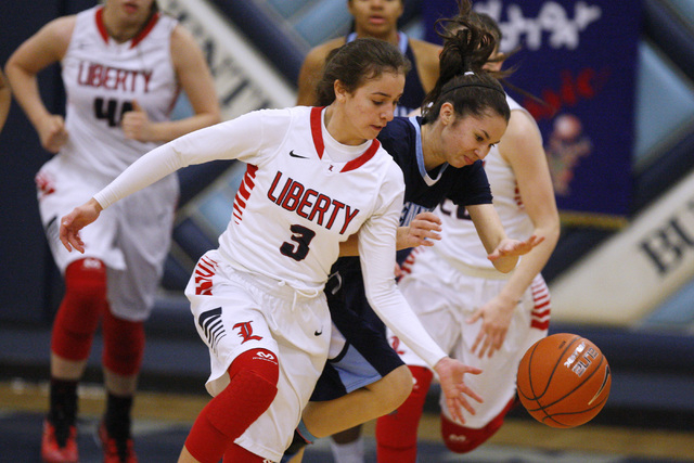 Liberty guard CeCe Quintino and Centennial guard Courtney Walker chase a loose ball during t ...