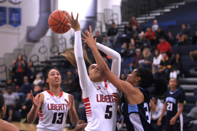 Centennial guard Megan Jefferson defends Liberty forward Jaelyn Royal during the championshi ...