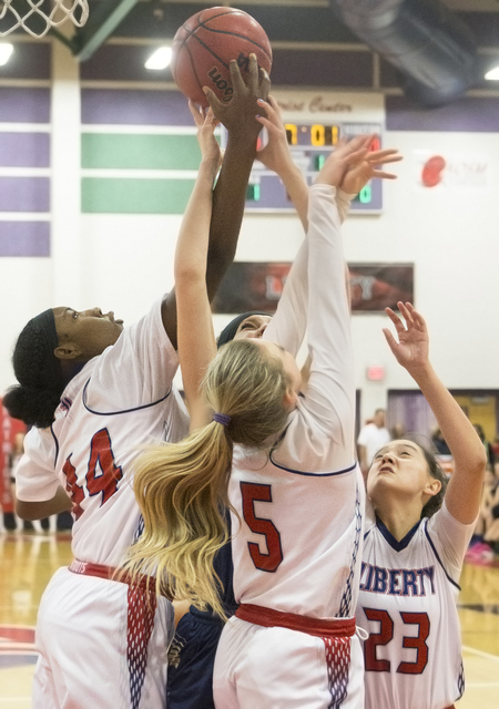 Liberty’s Dre’una Edwards (44) fights for a loose ball with teammates London Pav ...