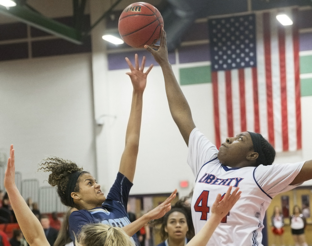 Foothills Rae Burrell (12) has her shot blocked by Liberty’s Dre’una Edwards (44 ...