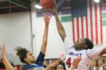 Foothills Rae Burrell (12) has her shot blocked by Liberty’s Dre’una Edwards (44 ...
