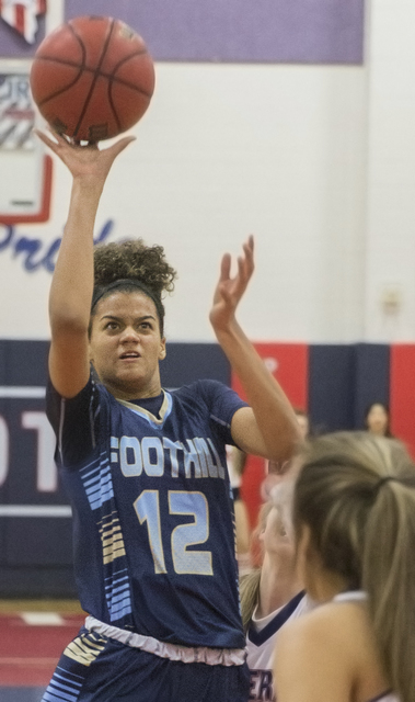 Foothill’s Rae Burrell (12) shoots a jump shot over Liberty’s London Pavlica (5) ...