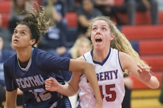 Liberty’s Amanda Pemberton (45) fights for position with Foothills Rae Burrell (12) du ...