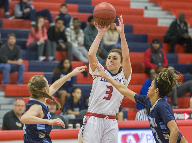 Liberty’s Celine Quintino (3) shoots a three point shot over Foothills Rae Burrell (12 ...