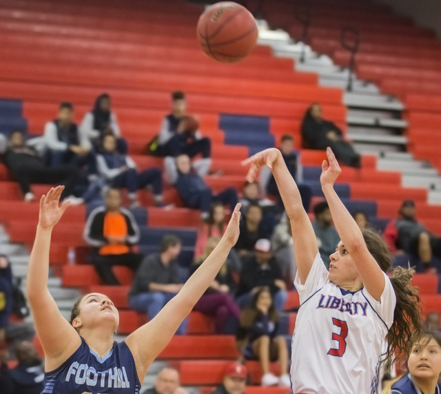 Liberty’s Celine Quintino (3) shoots a jump shot over Foothills Emily Capps (5) during ...