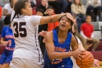 Bishop Gorman’s Skylar Jackson (20) gets fouled on the way to the basket by Desert Oas ...