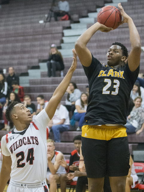 Clark’s Antwon Jackson (23) shoots a corner three point shot over Las Vegas’ Zac ...