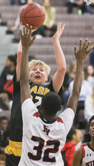 Clark’s Trey Woodbury (22) shoots over Las Vegas’ Kiaeem Gonzaque-Johnson (32) d ...