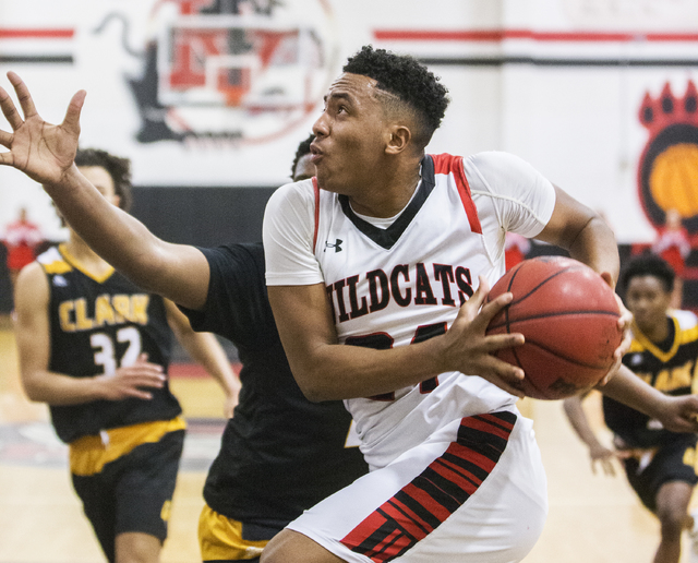 Las Vegas’ Vegas’ Zach Matlock (24) drives baseline past Clark defenders during ...