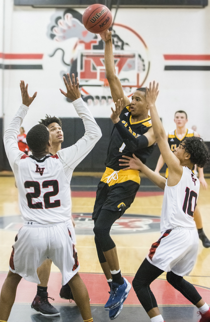 Clark’s Sedrick Hammond (1) makes a no look pass through Las Vegas defenders Zion Edw ...