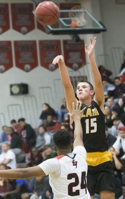 Clark’s James Bridges (15) shoots a three point shot over Las Vegas’ Zach Matloc ...