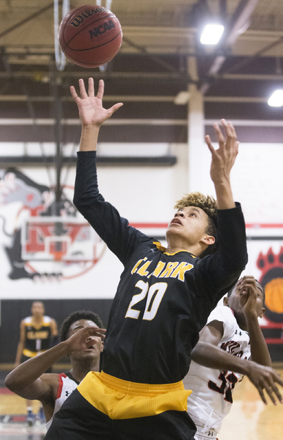 Clark’s Jalen Hill (20) reaches for a rebound over Las Vegas’ Kiaeem Gonzaque-Jo ...