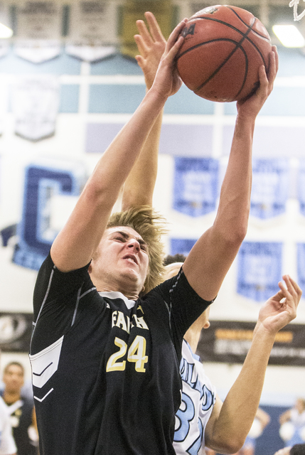 Faith Lutheran’s Nic Maccioni (24) grabs a rebound during the Crusaders road matchup w ...