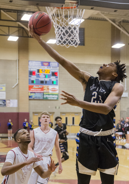 Sierra Vista’s Chris McCoy (23) shoot over Desert Oasis’ Manny Mitchell (5) on T ...