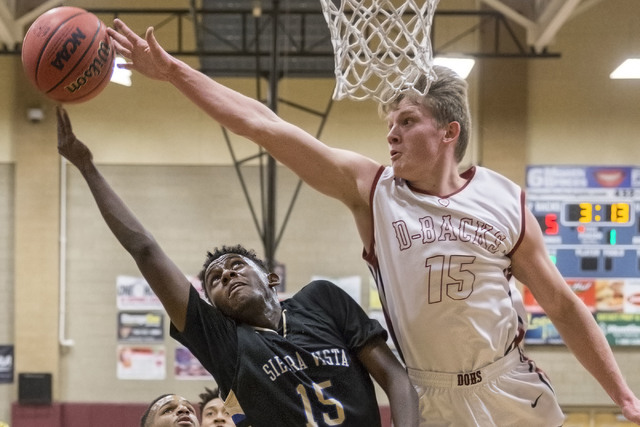 Sierra Vista’s Zekarias Kassaye (15) drives to the rim past Desert Oasis’ Jacob ...