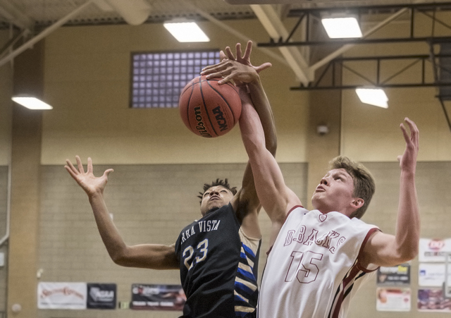 Desert Oasis’ Jacob Heese (15) fights for a rebound with Sierra Vista’s Chris Mc ...