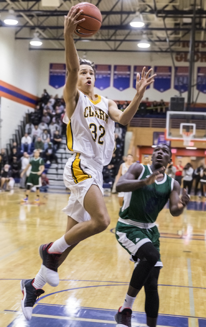 Clark’s Ian Alexander (32) converts a fast break layup past Chino Hills’ Elizjah ...