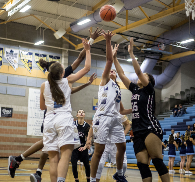 Players from Foothill and Desert Oasis jump for the ball during a game at Foothill High Scho ...