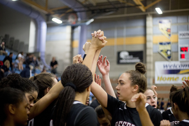 Players of Desert Oasis girls basketball team grasp hands after defeating Foothill 62-44 at ...