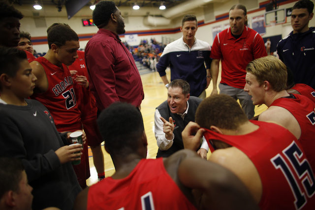 Coronado’s coach Jeff Kaufman talks to his team during a timeout at a basketball game ...