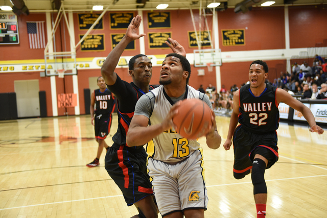 Clark’s Ty’Rek Wells (13) goes up for a shot against Valley defenders Nick Brann ...