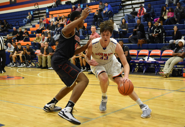 Bishop Gorman’s Stephen Zimmerman (33) dribbles past Corona Centennial’s Ike Ani ...