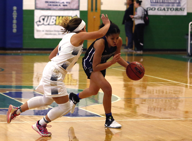 Durango’s Aaliyah Matthews (11) drives towards the hoop during a high school basketbal ...