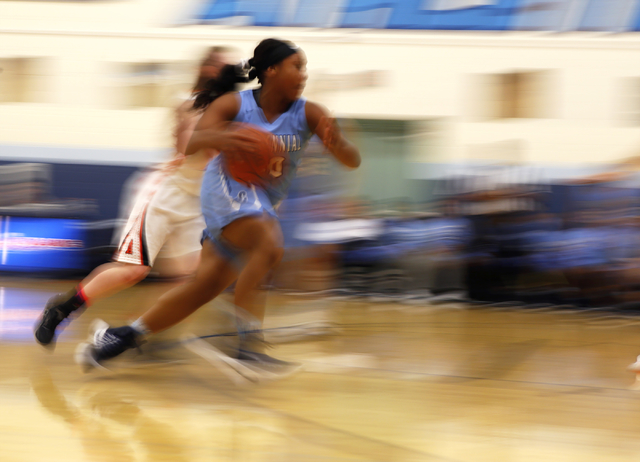 Centennial’s Tylise Taylor (30) drives towards the hoop during a high school basketba ...