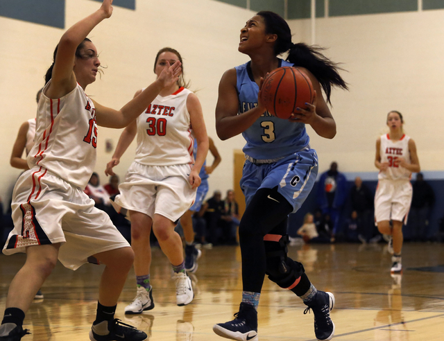 Centennial’s Lauren Welch (3) drives towards the hoop during a high school basketball ...