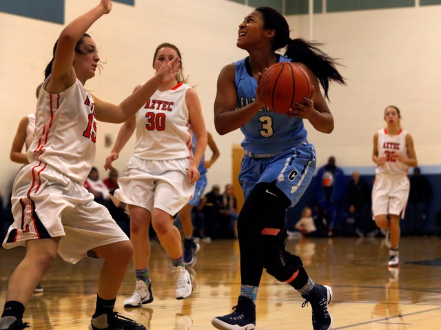 Centennial’s Lauren Welch (3) drives towards the hoop during a high school basketball ...