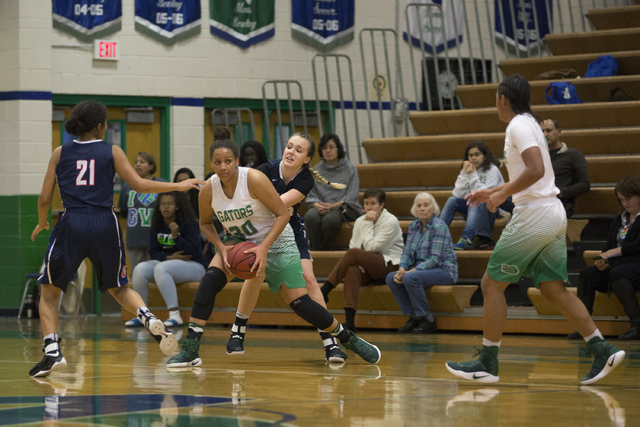 Green Valley junior Samar Miller (30) holds the ball and she looks for a player to pass to d ...