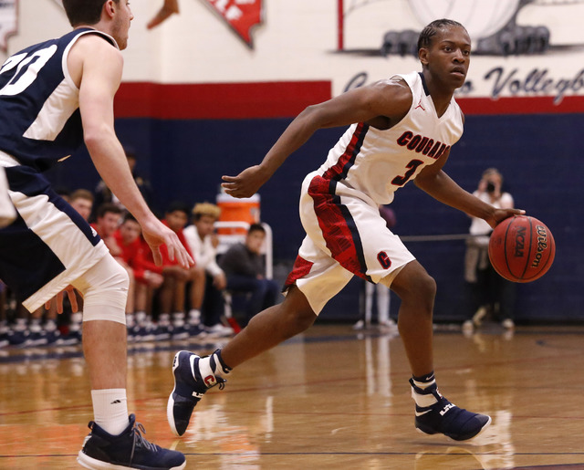 Coronado’s Nick Davis (3) looks for a pass during the first half of a high school bask ...