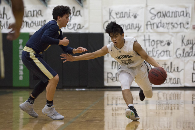 Palo Verde junior Dylan Yoro attempts to bring the ball to the basket while being guarded by ...