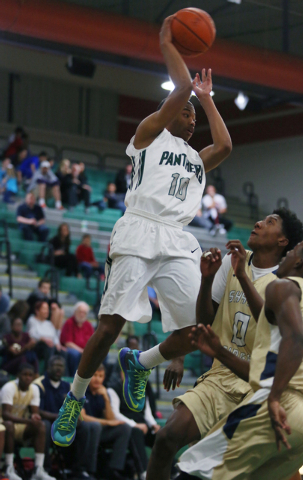 Palo Verde’s Ja Morgan, left, passes the ball around Shadow Ridge’s Jerell Sprin ...