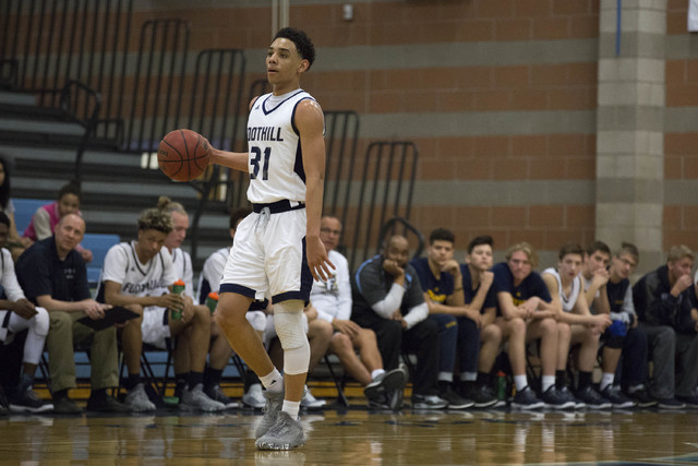 Foothill junior Marvin Coleman handles the ball as the team watches from the bench at Foothi ...