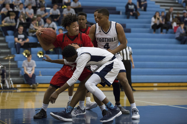 Las Vegas junior Donovan Joyner fights to keep possession of the ball at Foothill High Schoo ...