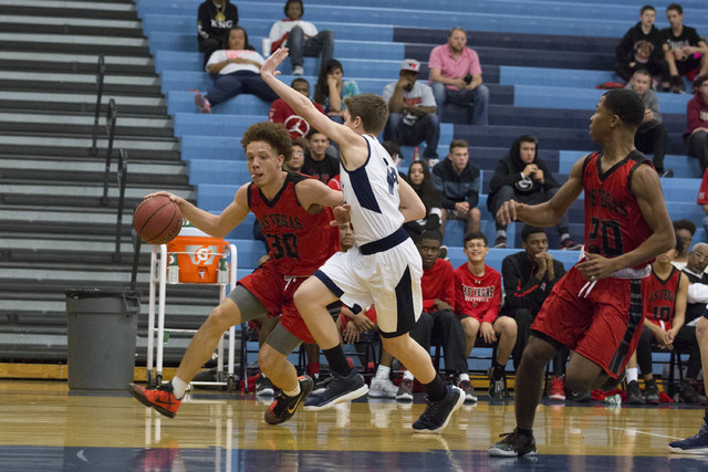 Las Vegas senior Jason Cullen attempts to drive the ball to the basket at Foothill High Scho ...