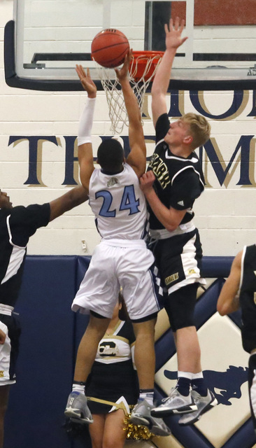 Centennial’s Adam Forbes (24) shoots as Clark’s Trey Woodbury (22) defends durin ...