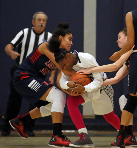 Liberty’s Paris Strawther, from left, Canyon Springs’ Alexia Thrower and Liberty ...