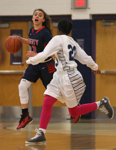 Liberty’s CeCe Quintino, left, drives against Canyon Springs’ Khelsea Smith duri ...