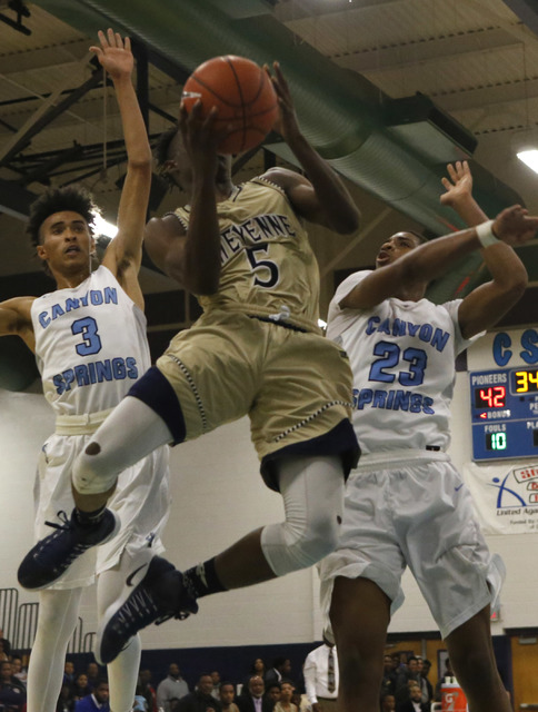 Cheyenne’s Kavon Williams (5) shoots against Canyon Spring’s Michael Washington ...