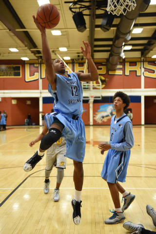 Canyon Springs Maurice Hunter (12) drives to the basket on Friday. Hunter scored seven as th ...