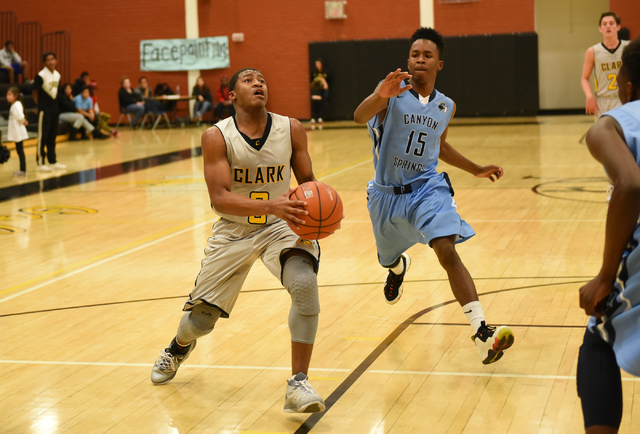 Clark’s Colby Jackson (0) drives past Canyon Springs’ Derrick Legardy (15) on Fr ...