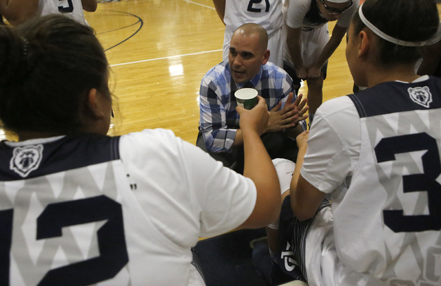 Spring Valley’s head coach Billy Hemberger speaks to the team during a basketball game ...