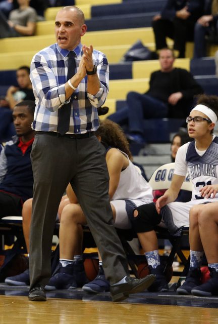 Spring Valley’s head coach Billy Hemberger claps during a basketball game at Spring Va ...