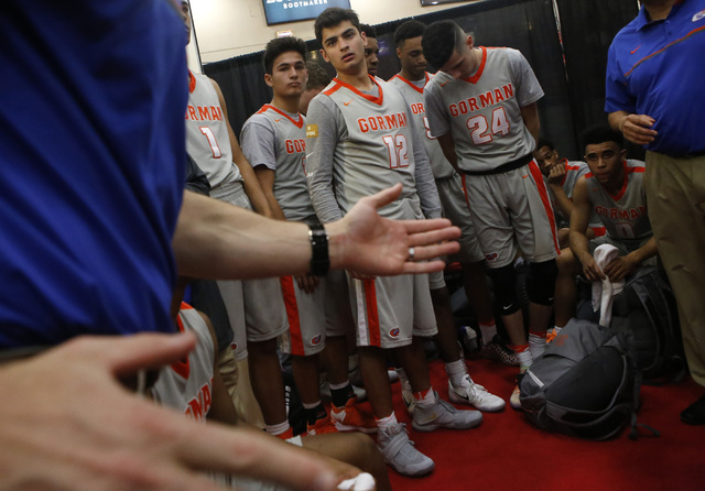 Bishop Gorman played listen to their coach at halftime during a high school basketball game ...