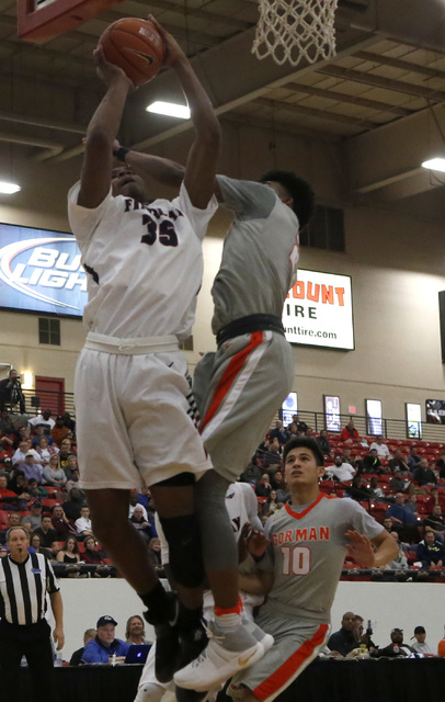 Findlay Prep’s Reggie Chaney (35) shoots during a high school basketball game at the S ...