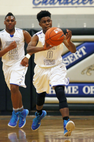 Desert Pines’ Curtis Henderson, right, looks to pass the ball during a game against Chapar ...